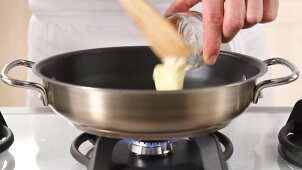 Butter being heated in a pan