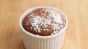 Chocolate souffle being dusted with icing sugar