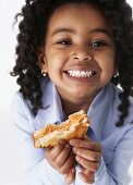 Girl holding toast with a bite taken