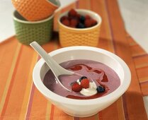 Sweet raspberry & blueberry soup with blob of cream