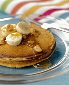 Pancakes with Banana Slices, Syrup and Peanuts