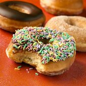 Glazed Donut with Sprinkles with Bite Taken Out of It, Assorted Donuts