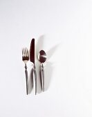 Set of Silver Ware on White Shot From Above