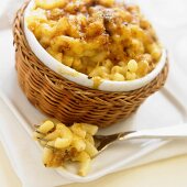 Baked Macaroni and Cheese in an Individual Baking Dish with Forkful Removed