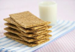 Stack of Many Graham Crackers with a Glass of Milk