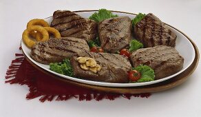 A Grilled Steak Platter with Mushrooms and Onion Rings