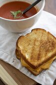 Whole Grilled Cheese Sandwich with a Bowl of Tomato Soup