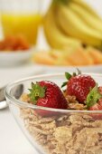 Bowl of Flake Cereal Topped with Fresh Strawberries