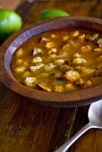 Bowl of Posole; Mexican Hominy and Pork Stew; On Wooden Table