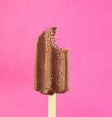 A chocolate ice lolly with a bite taken out