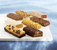 Various Protein Bars on a White Cutting Board