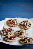Cookies Topped with Pistachios, Dried Fruit and Chocolate Drizzles