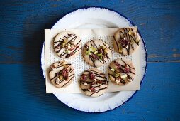Cookies Topped with Pistachios, Dried Fruit and Chocolate Drizzles; From Above