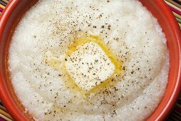 Butter Melting on a Bowl of Grits with Cracked Pepper; From Above