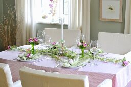 A festively decorated dining table with a flower arrangment