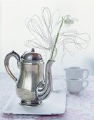 Snowdrops in a teapot decorated with wire