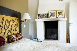 A bedroom with a fireplace