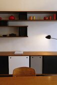 Table lamp providing light for a sideboard and wall shelves