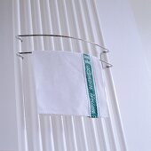 A tea towel on a towel rail on a radiator