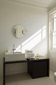 A designer washstand with a mirror in the bathroom of a country house