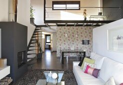 Designer-Maisonettewohnung - Kamin im Wohnraum und Galerie mit Treppe