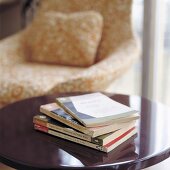 A stack of books on a side table