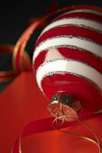 Red and white striped Christmas baubles with ribbon