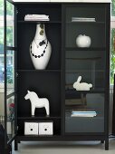 Modern black display cabinet with white knickknacks