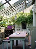 Country style wooden table and bench seat in conservatory