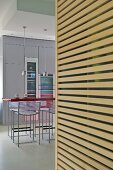 Bar stools at breakfast bar in modern kitchen