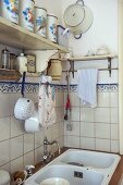 Corner of modern kitchen with tiled wall