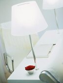 A detail of a room in the Sanderson Hotel, pair of chrome lamps on desk table, lap top computer, chair