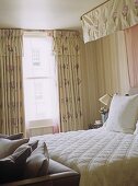 Double bed with canopy in pink and green bedroom