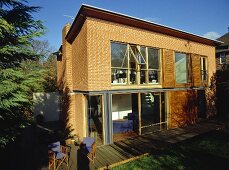 Exterior of new built red brick house with decked terrace