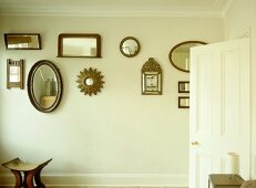 Collection of various mirrors displayed on wall