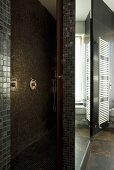 A shower area with designer brown and gold mosaic tiles