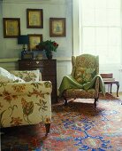 Various upholstered armchairs on an oriental rug in a traditional living room