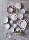 Porcelain cups on a bright green stone floor