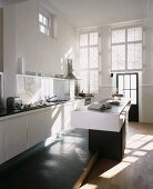 A designer kitchen with a black and white island counter