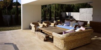 A white terrace with wicker furniture in a newly-built house