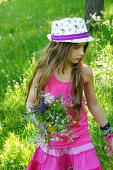 A girl with a bunch of meadow flowers