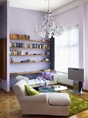 A chaise lounge, a day bed and a shelf in a living room with pink walls