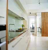 A kitchen counter with white cupboards