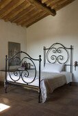 A wrought iron bedstead in a bedroom