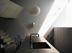 Kitchen unit with integrated sink and white hanging lamp in a designer kitchen