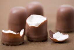 Three whole chocolate marshmallows and one broken one