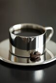 Coffee in silver cup and saucer