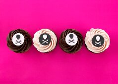 Four cupcakes with pirate decoration