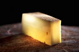 A piece of Allgäu mountain cheese, hard cheese from raw milk
