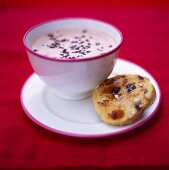 Cup of hot chocolate and raisin roll